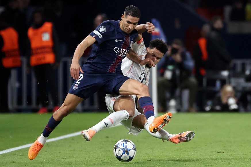 epa12503565 Acharaf Hakimi of Paris Saint Germain (L) is fouled by Luis Diaz of Bayern Munich in action during the UEFA Champions League phase match between PSG and FC Bayern Munich in Paris, France,  ...
