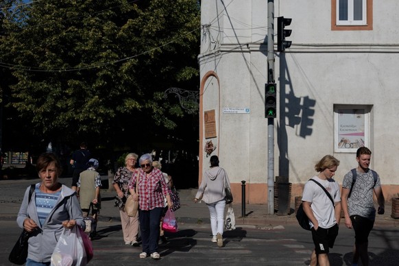 (FILES) Pedestrians walk down the street in Berehove on August 28, 2026, amid the Russian invasion of Ukraine. Nestled in the foothills of the Carpathian mountains and tucked between Slovakia, Hungary ...