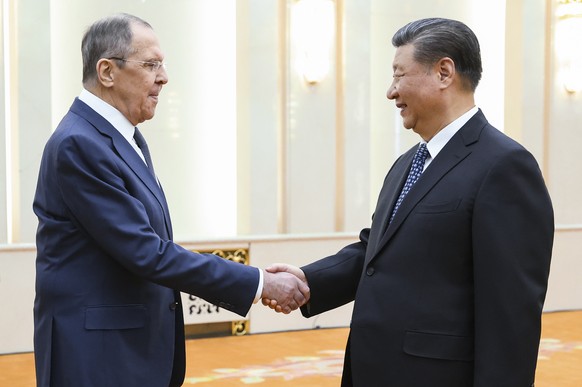 epa11267587 A handout picture made available by the Russian Foreign Ministry press service shows Russian Foreign Minister Sergey Lavrov (L) meeting Chinese President Xi Jinping at the Great Hall of th ...