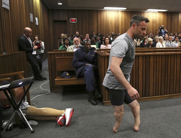 2016 AP YEAR END PHOTOS - Oscar Pistorius&#039; prosthetics lie on the floor as he walks on his amputated legs during argument in mitigation of sentence by his defense attorney Barry Roux in the High  ...