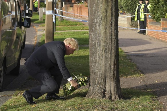 epa09526879 A handout photo made available by No. 10 Downing Street of Boris Johnson, Sir Keir Starmer and Priti Patel pay respects to Sir David Amess at Belfairs Methodist Church, in Leigh-on-Sea, Un ...