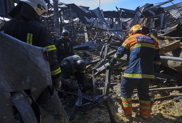 epaselect epa11371759 Communal workers clear debris following yesterday&#039;s shelling of the hypermarket in Kharkiv, Ukraine, 26 May 2024 amid the Russian invasion. Russian troops shelled by two gli ...