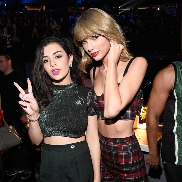 NEW YORK, NY - DECEMBER 12: Charli XCX (L) and Taylor Swift pose backstage at iHeartRadio Jingle Ball 2014, hosted by Z100 New York and presented by Goldfish Puffs at Madison Square Garden on December ...