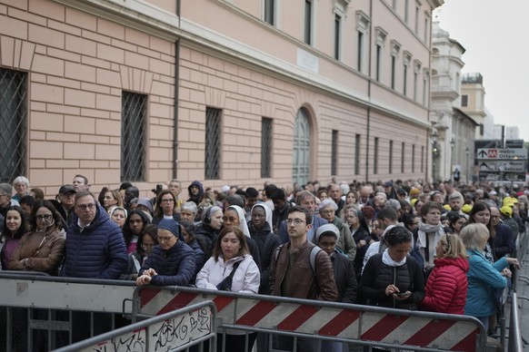 People wait in line to view Pope Francis lying in state inside St. Peter&#039;s Basilica, at the Vatican, Thursday, April 24, 2025. (AP Photo/Markus Schreiber)
Vatican Pope