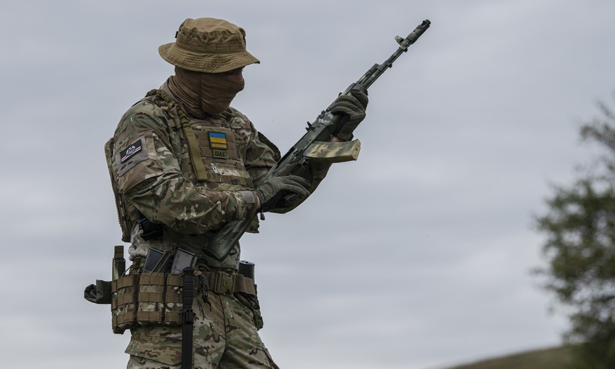 A volunteer soldier attends a training outside Kyiv, Ukraine, Saturday, Aug. 27, 2022. Some volunteers signed up to join a Chechen unit that fights alongside the Ukrainian military. Fighters from Chec ...