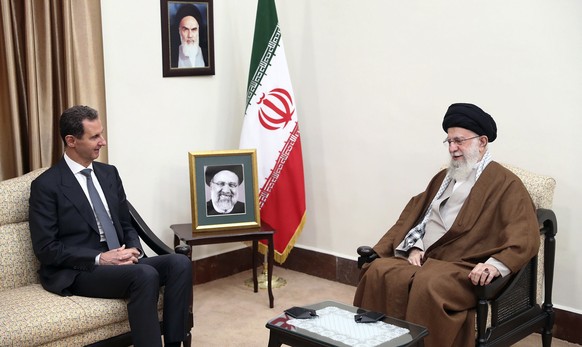 FILE - In this photo released by the official website of the office of the Iranian supreme leader, Supreme Leader Ayatollah Ali Khamenei, right, speaks with Syrian President Bashar Assad in a meeting  ...