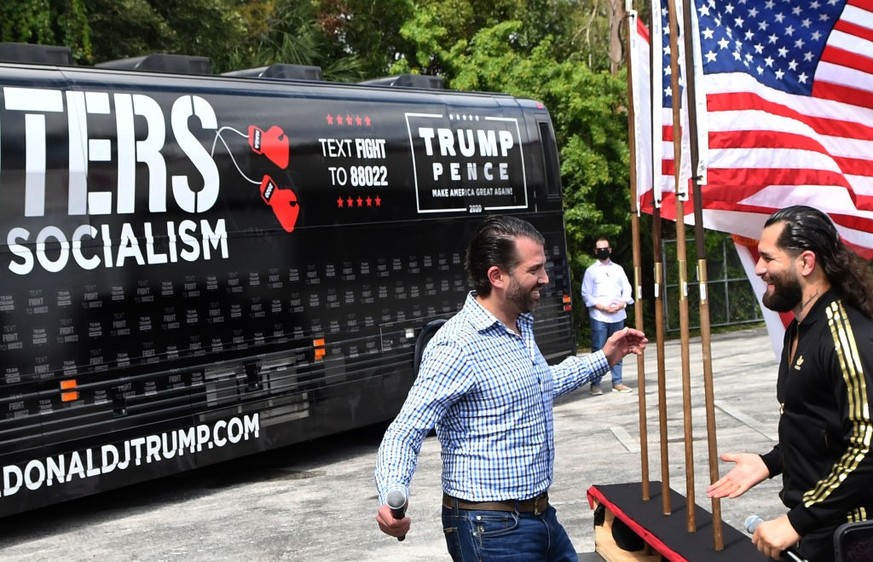 ORLANDO, FLORIDA, UNITED STATES - 2020/10/11: Donald Trump Jr greets UFC fighter Jorge Masvidal as they both speak in support of U.S. President Donald Trump at a Fighters Against Socialism campaign ra ...