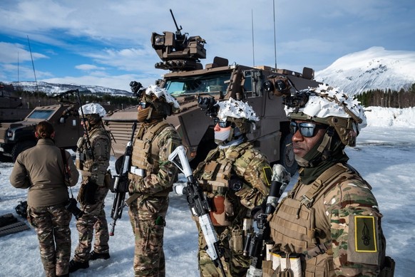 Members of the 2nd Foreign Infantry Regiment (2e REI) stand in front of a Griffon (VBMR) multi-role armored vehicle during a demonstration near Setermoen on March 12, 2026, as NATO conducts its Cold R ...
