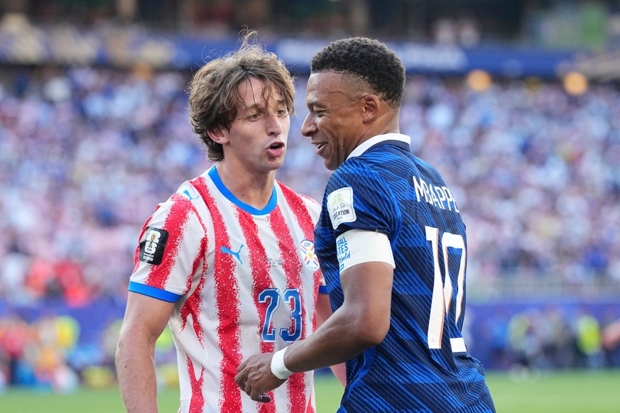 Paraguay's Matias Galarza (23) talks with France's Kylian Mbappe (10) during the World Cup round of 16 soccer match between Paraguay and France in Philadelphia, Saturday, July 4, 2026. (AP P ...