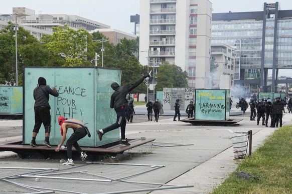 Youth throws a bottle to police forces during riots Thursday, June 29, 2023 in Nanterre, outside Paris. The killing of 17-year-old Nahel during a traffic check Tuesday, captured on video, shocked the  ...