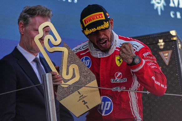 Ferrari driver Lewis Hamilton of Britain celebrates after wining the Spain F1 Grand Prix race at the Barcelona Catalunya racetrack in Montmelo, near Barcelona, Spain, Sunday, June 14, 2026. (AP Photo/ ...