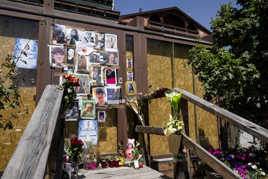 epa13100249 Portraits of the young victims are displayed at the entrance of the bar Le Constellation six months after a deadly fire, in Crans-Montana, Switzerland, 09 July 2026. Forty-one people, most ...