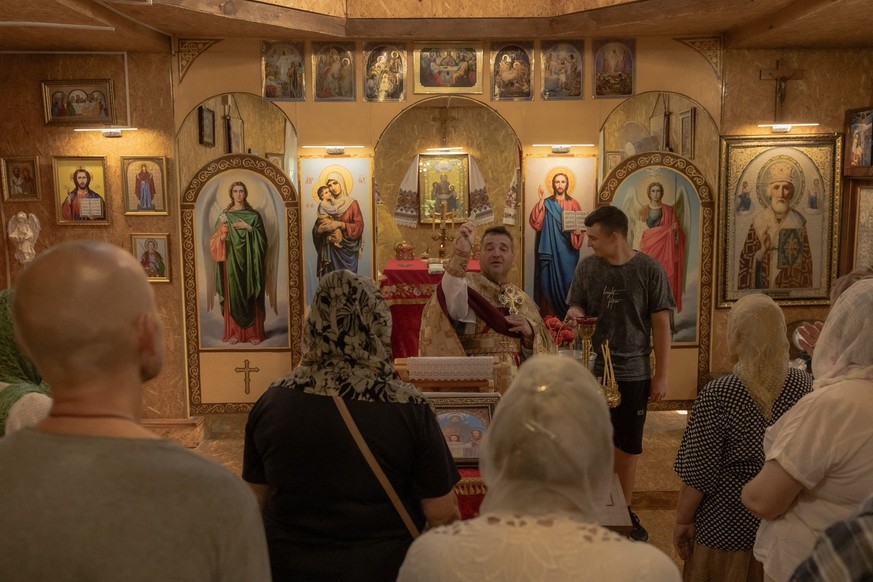 Archpriest Oleksandr Tkachuk, 53, leads a prayer service at the Church of the Holy Martyrs Vira, Nadiya, Lyubov, and Mother Sophia of the Orthodox Church of Ukraine, in Kramatorsk, which is aligned wi ...