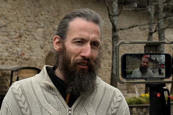 Father Dmitry, 45, who is on a pilgrimage to Pechory, talks to AFP reporters on the grounds of the Pskovo-Pechersky monastery in the town of Pechory, some 50 kilometres outside Pskov, on April 19, 202 ...