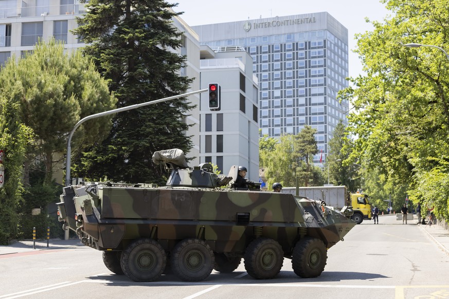 An armored vehicle and a truck block access to the Inter Continental hotel before the arrival of United States President Joe Biden, Tuesday, June 15, 2021, in Geneva, Switzerland. The meeting between  ...