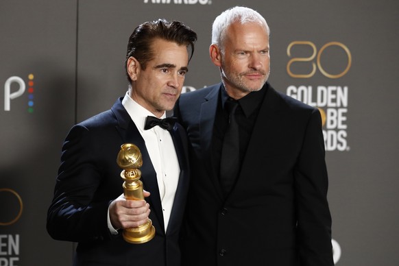 epa10399372 Colin Farrell (L) and Martin McDonagh (R) pose with the award for Best Picture - Musical/Comedy in the press room during the 80th annual Golden Globe Awards ceremony in Beverly Hills, Cali ...