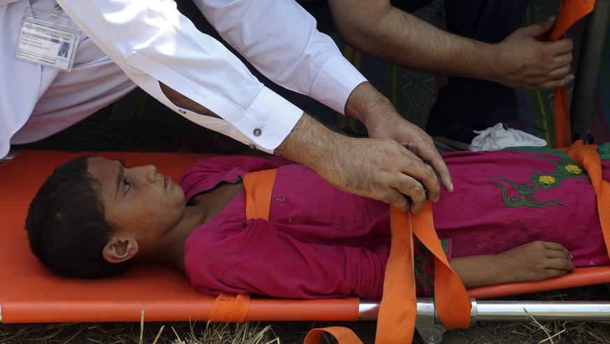Pakistani health workers carry a sick girl who's family had to flee their flood-hit home, in Charsadda, Pakistan, Monday, Aug. 29, 2022. International aid was reaching Pakistan on Monday, as the ...