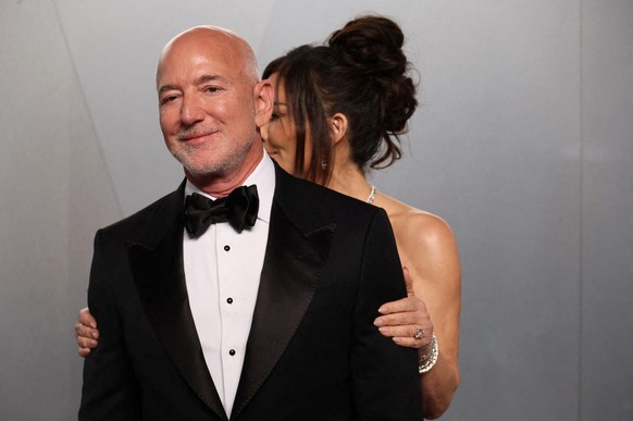 FILE PHOTO: Lauren Sanchez Bezos and Jeff Bezos arrive at the Vanity Fair Oscars party after the 98th Academy Awards, in Beverly Hills, California, U.S., March 15, 2026. REUTERS/Danny Moloshok/File Ph ...