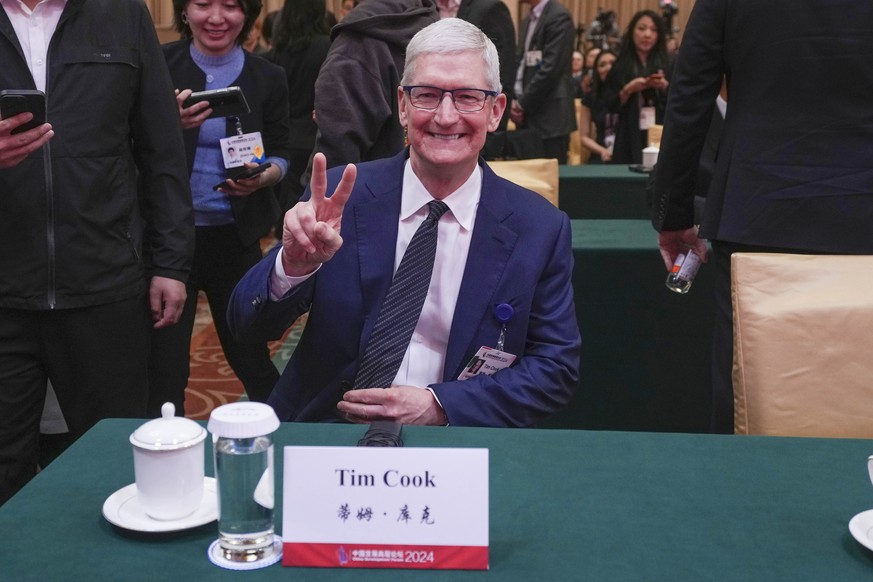 Apple CEO Tim Cook reacts before a parallel session of the China Development Forum at the Diaoyutai State Guesthouse in Beijing, China, on Sunday, March 24, 2024. (AP Photo/Tatan Syuflana)