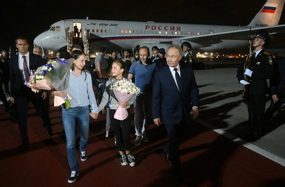 epa11517271 Russian President Vladimir Putin (R) meets Russian citizens released after the Russian-US prisoner swap in Turkiye at Vnukovo International Airport in Moscow, Russia, 01 August 2024. On Au ...