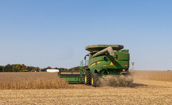 Combine Harvesting a Soybean Crop, PETERSBURG, ILLINOIS/USA-October 6, 2020: John Deere combine harvesting a soybean crop