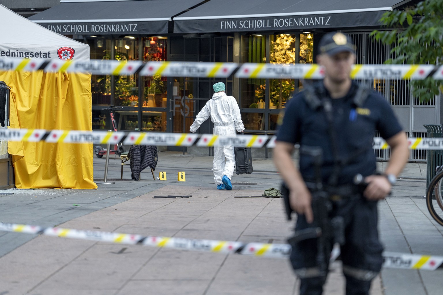 Police at the scene of a shooting in central Oslo, Saturday, June 25, 2022. Norwegian police say they are investigating an overnight shooting in Oslo that killed two people and injured more than a doz ...