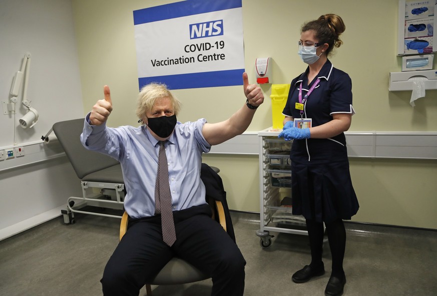 FILE - Britain&#039;s Prime Minister Boris Johnson gestures after receiving the first dose of the AstraZeneca vaccine administered by nurse and Clinical Pod Lead, Lily Harrington at St.Thomas&#039; Ho ...