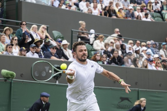 Stanislas Stan Wawrinka of Switzerland returns the ball to Charles Broom of Great Britain during their first match of the All England Lawn Tennis Championships in Wimbledon, London, Monday, July 1, 20 ...