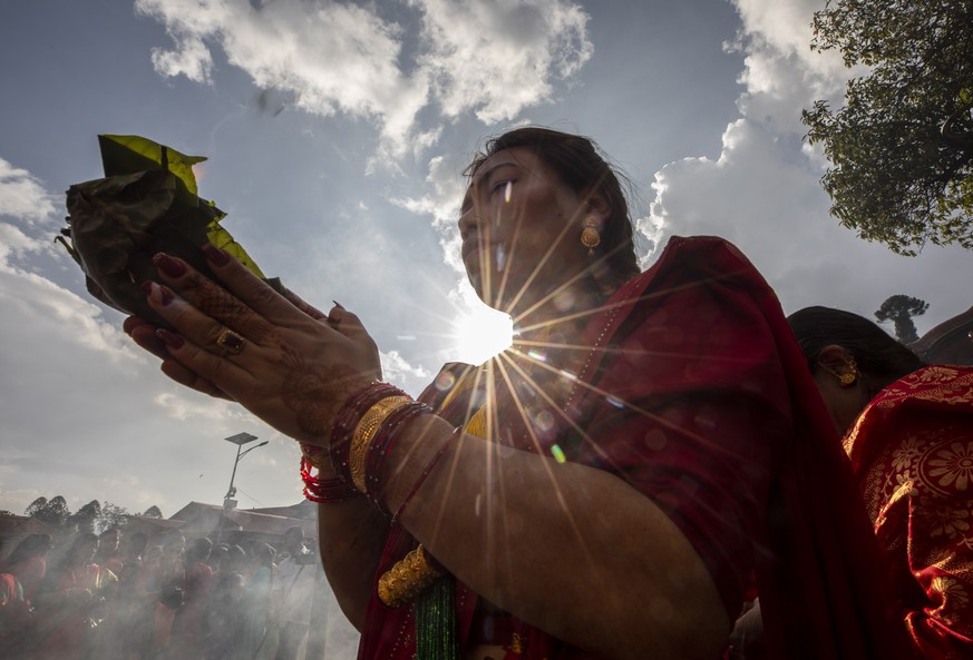 epa10147095 Women wearing red attire worship Lord Shiva, god of creation and destruction, during Teej festival at Pashupatinath temple in Kathmandu, Nepal, 30 August 2022. Married Nepalese women celeb ...