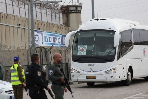 epa10994358 The Bus of the International Committee of the Red Cross (ICRC) arrives at the West Bank military prison of Ofer, north of Jerusalem, 25 November 2023, ahead of an expected release of Pales ...