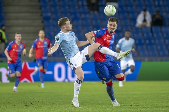 Bratislava&#039;s goalkeeper Adam Hrdina, left, against Basel&#039;s Andi Zeqiri, right, during the UEFA Conference League round of 16 first leg match between Switzerland&#039;s FC Basel 1893 and Slov ...