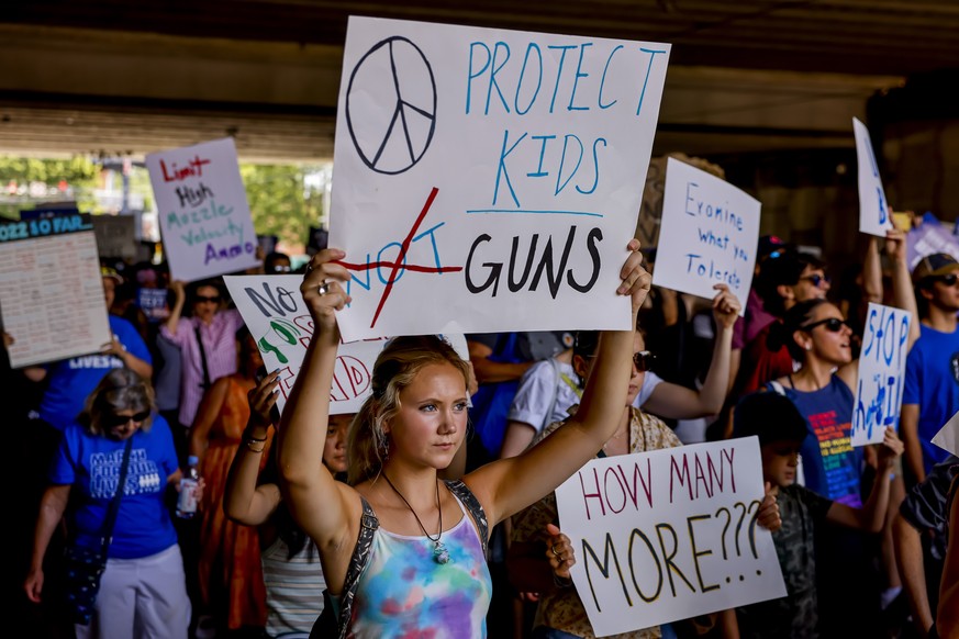 epa10008665 People hold placards while participating in the March For Our Lives demonstration against gun violence in Atlanta, Georgia, USA, 11 June 2022. The nationwide anti gun violence marches come ...