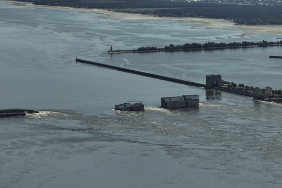 CAPTION CORRECTS LOCATION - Water flows over the collapsed Kakhovka Dam in Nova Kakhovka, in Russian-occupied Ukraine, Wednesday, June 7, 2023. (AP Photo)