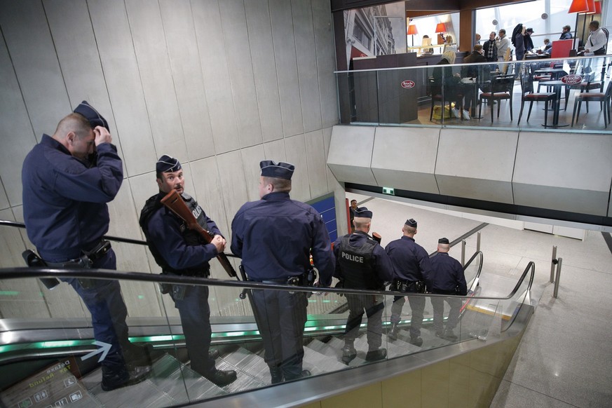 Police officers patrol at Charles de Gaulle airport, outside of Paris, Thursday, May 19, 2016. An EgyptAir flight from Paris to Cairo with 66 passengers and crew on board crashed into the Mediterranea ...