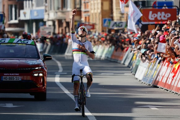 Slovenia's Tadej Pogacar of the UAE Team Emirates crosses the finish line to win the Belgian cycling classic and UCI World Tour race Liege Bastogne Liege, in Liege, Belgium, Sunday, April 26, 202 ...