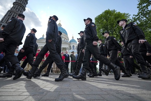 Russian conscripts march during a send-off event before they head to assigned military units for mandatory one-year military service in front of the Trinity Cathedral in St. Petersburg, Russia, Tuesda ...