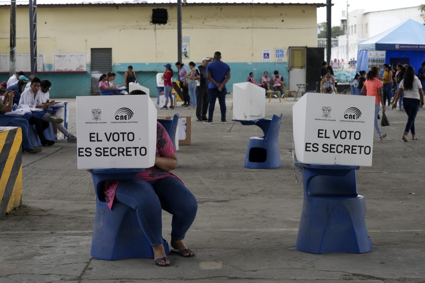 A voter marks his ballot during the snap presidential election, in Guayaquil, Ecuador, Sunday, Aug. 20, 2023. The election was called after President Guillermo Lasso dissolved the National Assembly by ...