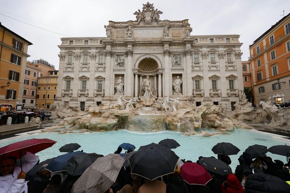 epaselect epa11790109 People look at the Trevi Fountain and take pictures as it reopens to the public after undergoing maintenance, in Rome, Italy, 22 December 2024. The 18th-century Fontana di Trevi  ...