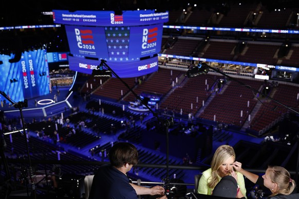epa11554663 A news anchor preps to be on camera at the United Center ahead of the Democratic National Convention (DNC) in Chicago, Illinois USA, 18 August 2024. The Democratic National Convention is d ...