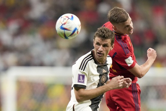 Germany&#039;s Thomas Mueller, left, and Spain&#039;s Ferran Torres jump for the ball during the World Cup group E soccer match between Spain and Germany, at the Al Bayt Stadium in Al Khor , Qatar, Su ...