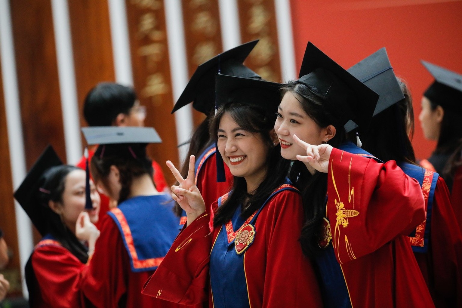 epa10711905 Graduates pose for a photo during the degree awarding ceremony at Renmin University in Beijing, China, 26 June 2023. A record high of 11.6 million people are expected to graduate from univ ...