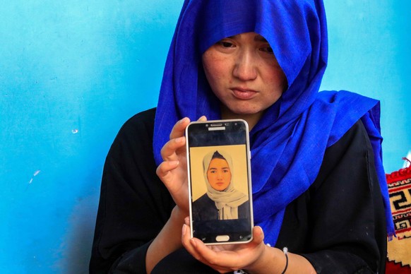 epa10216123 A relative of Hasina, an 18 years old afghan girl, who was killed in a suicide bomb attack at a school, during a prepration for university entrance exams, in a Shia Hazara neighborhood, di ...