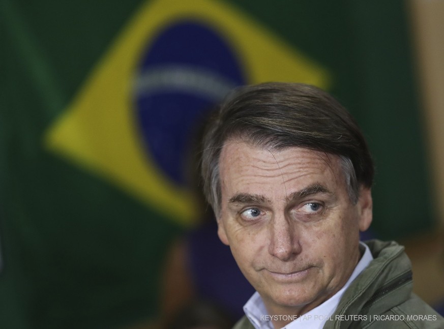 Jair Bolsonaro, presidential candidate with the Social Liberal Party, arrives to cast his vote in the presidential runoff election in Rio de Janeiro, Brazil, Sunday, Oct. 28, 2018. Bolsonaro is runnin ...