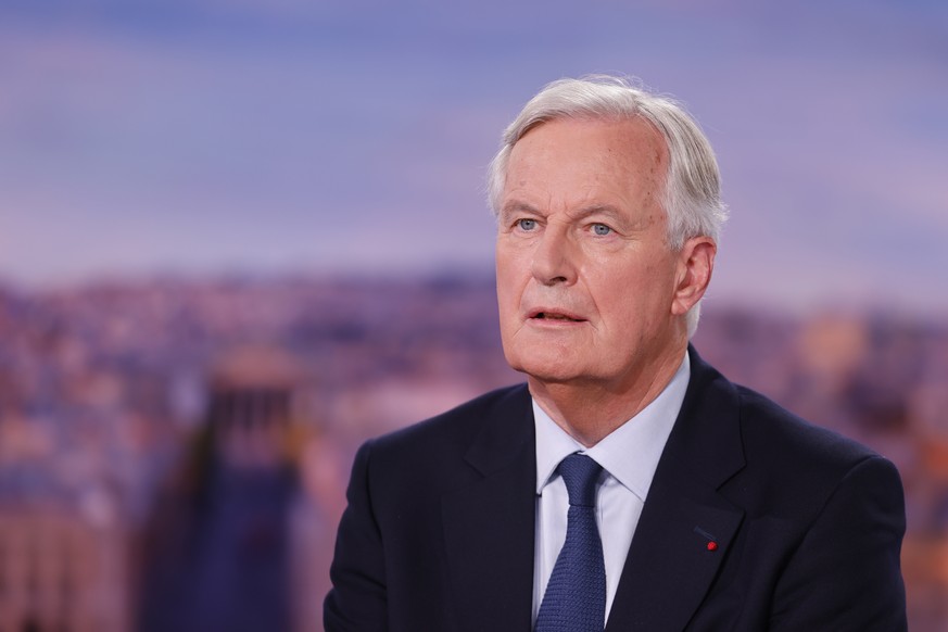 epa11590284 France&#039;s newly appointed Prime Minister, Michel Barnier speaks during the evening news broadcast of French TV channel TF1 with French journalist and TV host Anne-Claire Coudray, in Bo ...