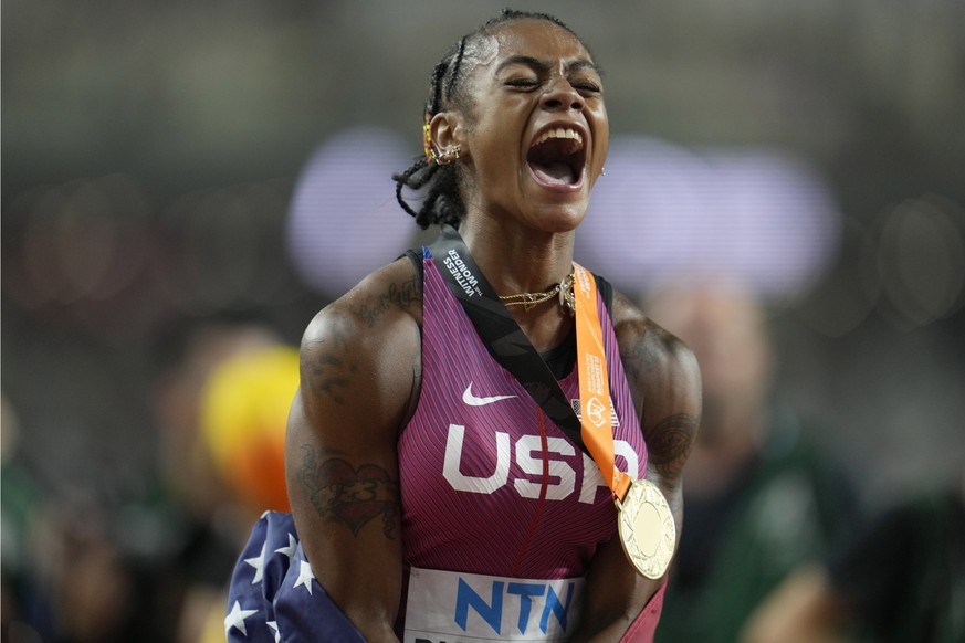 Sha&#039;Carri Richardson, of the United States, shouts out as she celebrates with her gold medal for winning the women&#039;s 100 meters during the World Athletics Championships in Budapest, Hungary, ...