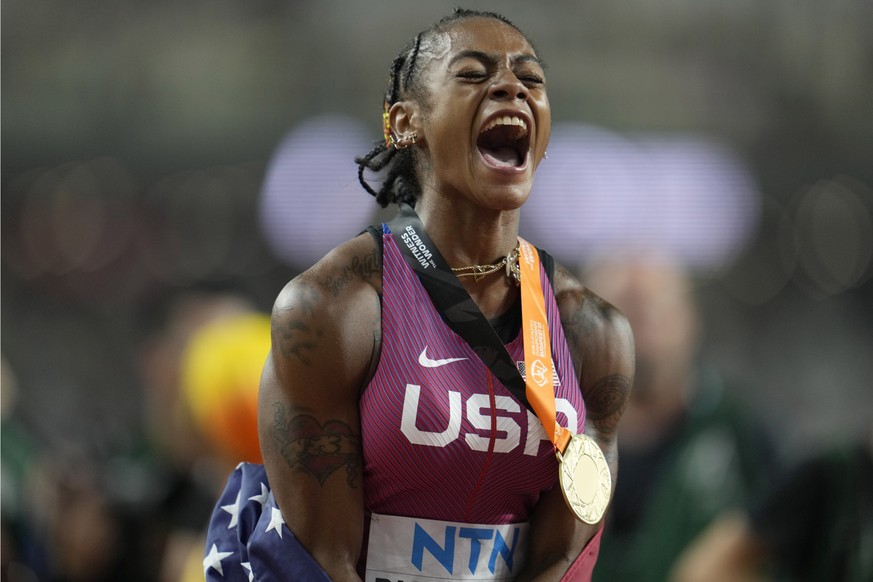 Sha&#039;Carri Richardson, of the United States, shouts out as she celebrates with her gold medal for winning the women&#039;s 100 meters during the World Athletics Championships in Budapest, Hungary, ...