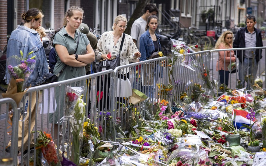 epa09341048 The sea of flowers for crime reporter Peter R. de Vries in the Lange Leidsedwarsstraat in the center of Amsterdam, the Netherlands, 12 July 2021. De Vries was shot in Amsterdam, shortly af ...