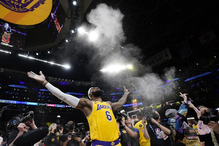 Los Angeles Lakers forward LeBron James tosses powder in the wire prior to an NBA basketball game against the Oklahoma City Thunder Tuesday, Feb. 7, 2023, in Los Angeles. (AP Photo/Ashley Landis)