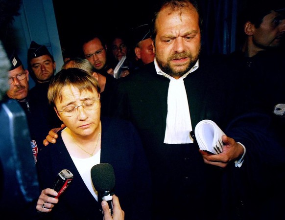 (FILES) In this file photo taken on July 2, 2004 defendant Roselyne Normand (L) and her lawyer Dupond-Moretti leave the court after the end of a major child sex trial, in Saint Omer. - Normand, a bake ...