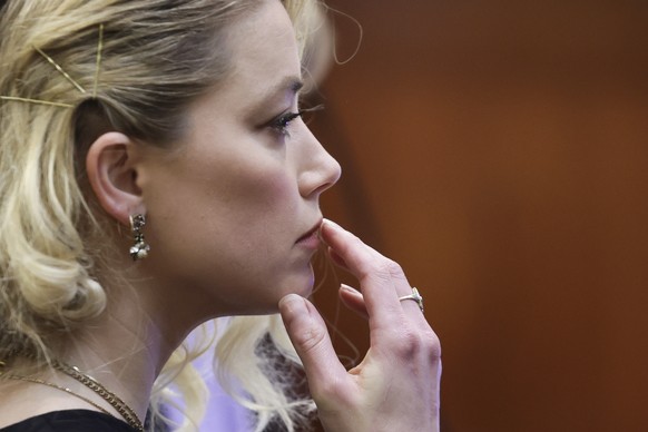 Actor Amber Heard waits before the verdict was read at the Fairfax County Circuit Courthouse in Fairfax, Va, Wednesday, June 1, 2022. The jury awarded Johnny Depp more than $10 million in his libel la ...